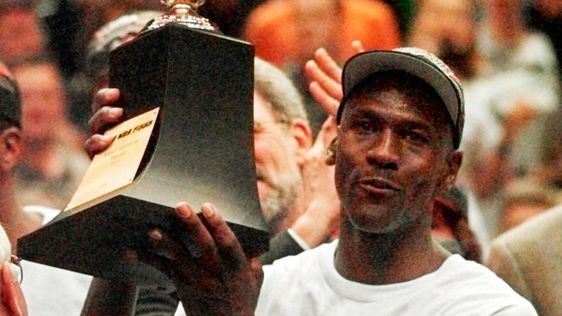 Basketball legend Michael Jordan, shown holding the Series MVP trophy on June 14, 1998, after the Chicago Bulls defeated the Utah Jazz 87-86 in to win the NBA championship in Game 6 of the finals in Salt Lake City.