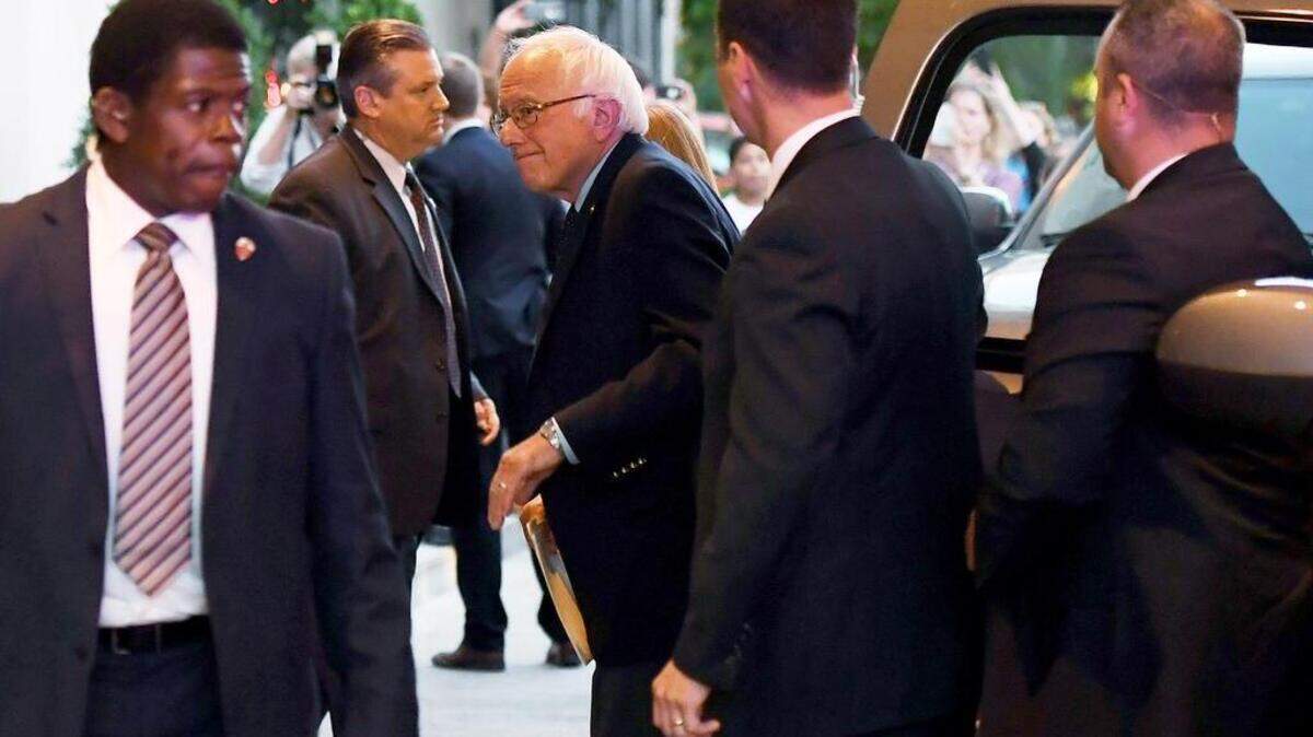 Democratic presidential candidate Bernie Sanders arrives at the Capital Hilton last week, his Secret Service detail in tow, to meet with rival and presumptive nominee Hillary Clinton.