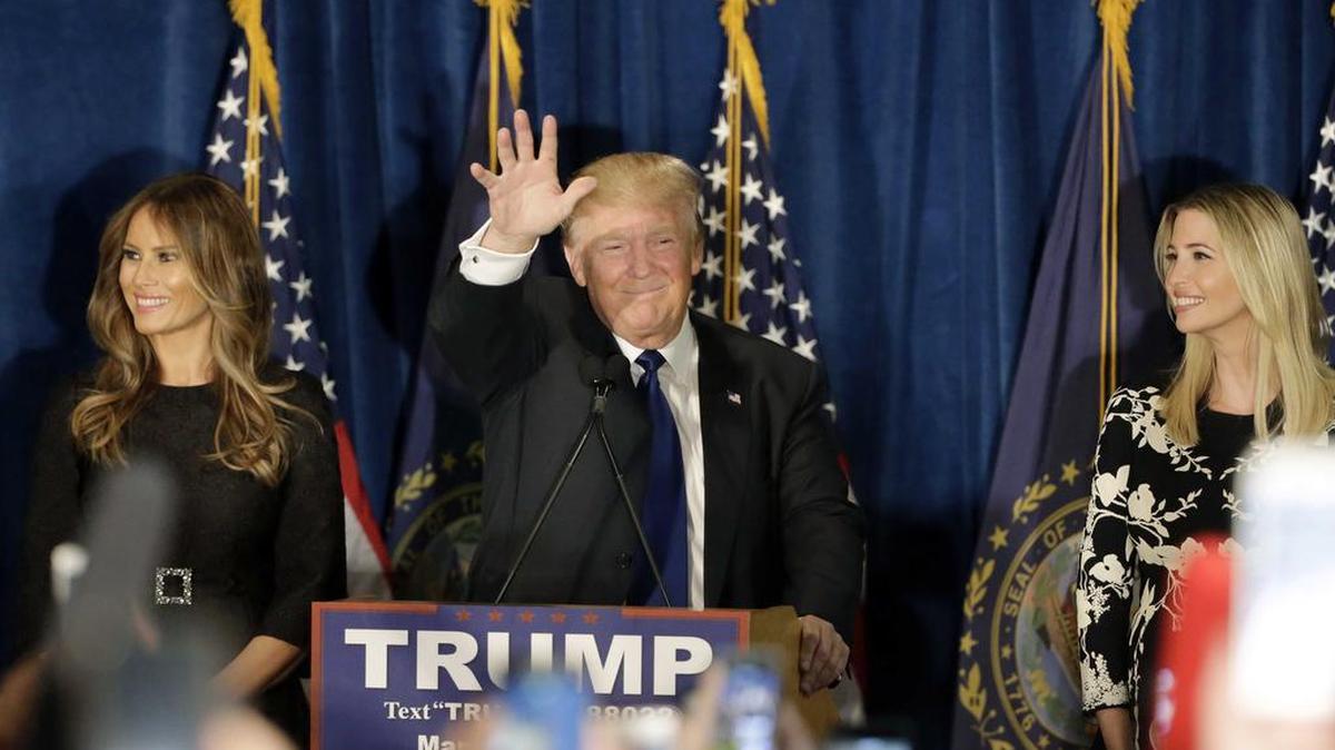 Republican presidential candidate, businessman Donald Trump speaks to supporters during a primary night rally, Feb. 9, 2016, in Manchester, N.H. At his side are his wife Melania Trump, left, and daughter Ivanka Trump, right.