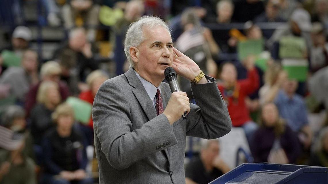 Republican Rep. Tom McClintock bends his ear to hear questions from a boisterous crowd during his town hall meeting at Oak Ridge High School in El Dorado Hills, Calif., on March 4, 2017.