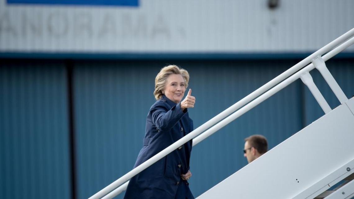 Democratic presidential candidate Hillary Clinton gives a thumbs up to members of the media as she boards her campaign plane in White Plains, N.Y., Tuesday, Oct. 4, 2016, to travel to Philadelphia International Airport. Clinton is attending rallies in Haverford, Pa. and Harrisburg, Pa.