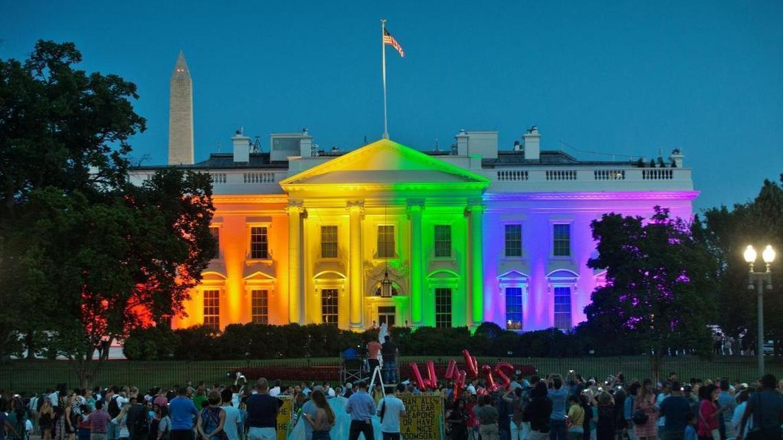 People gather in Washington's Lafayette Park to see the White House illuminated with rainbow colors to mark the U.S. Supreme Court's ruling to legalize same-sex marriage on June 26, 2015.