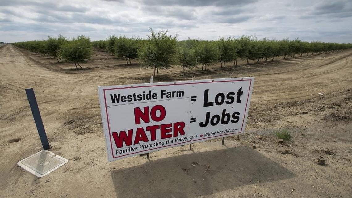 Signs such as this one dot the landscape around farms near Huron, California, in the Westlands Water district west of Fresno.
