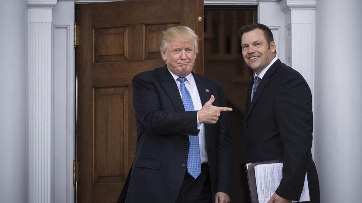 Then-President-elect Donald Trump greets Kansas Secretary of State Kris Kobach at the clubhouse at Trump National Golf Club Bedminster in Bedminster Township, N.J.