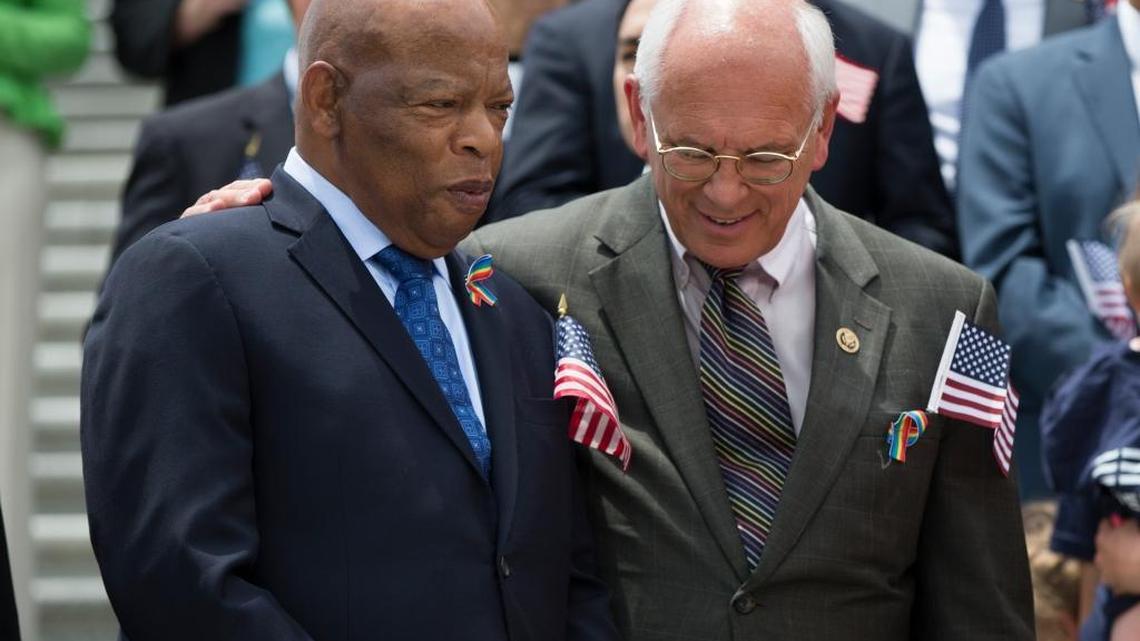 FILE – Rep. Paul Tonko, D-N.Y., right, puts his arm around Rep. John Lewis, D-Ga., during an news conference on gun legislation, Wednesday, June 22, 2016, on Capitol Hill in Washington. LGBT advocates say black lawmakers like Lewis are important leaders to help Democrats unify behind equality issues.
