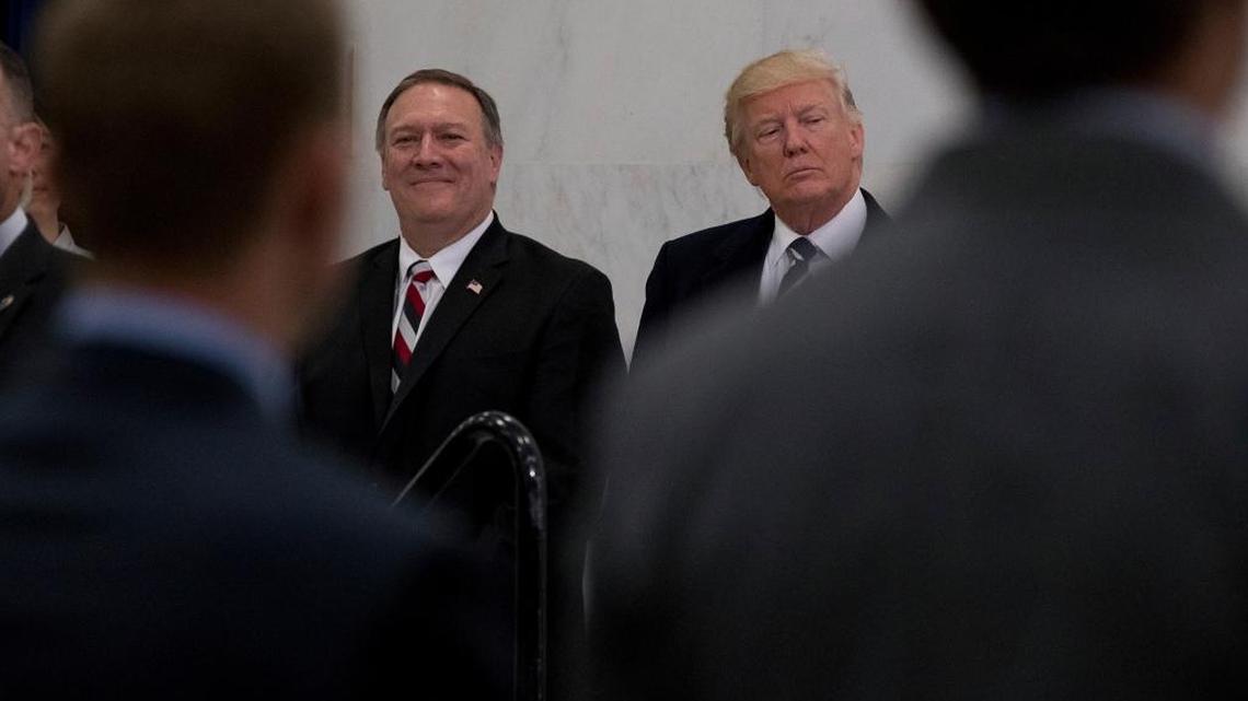 President Donald Trump, accompanied by CIA Director-designate Mike Pompeo, left, waits to speak at the Central Intelligence Agency in Langley, Va., Saturday, Jan. 21, 2017.