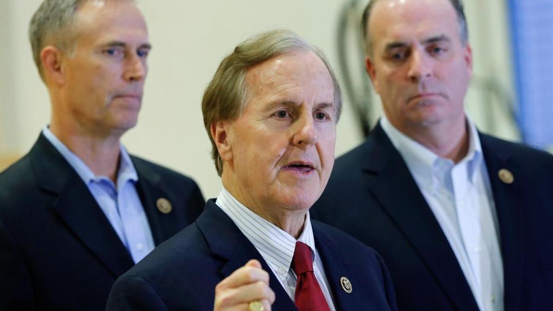 U.S. Representatives Robert Pittenger, center, Dan Kildee, right, and Jared Huffman, left, talk to the media,
