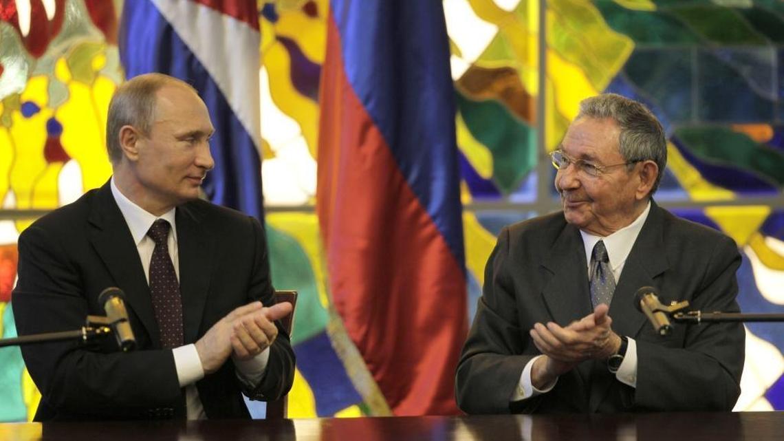 Russia's President Vladimir Putin, left, and Cuba's President Raul Castro applaud at Revolution Palace in Havana, Cuba, Friday, July 11, 2014.