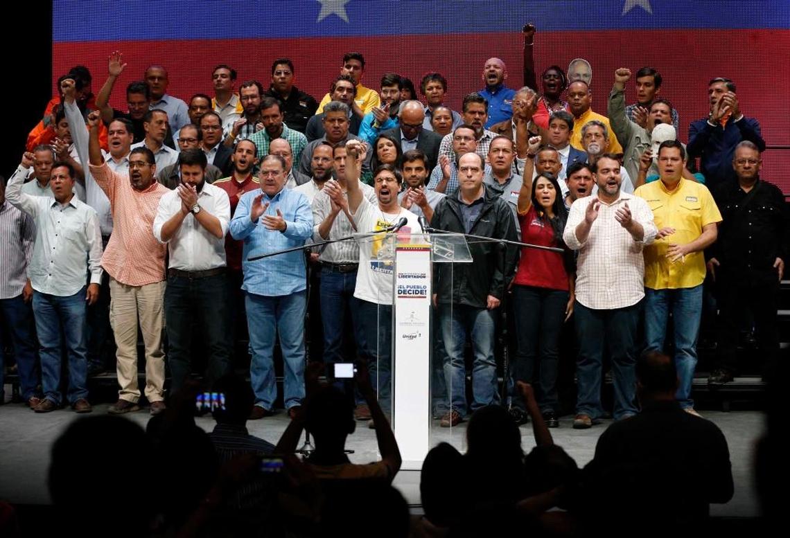 National Assembly first Vice President Freddy Guevara, center, raises his arm, accompanied by lawmakers in Caracas, Venezuela, on Monday. Venezuelan opposition leaders called Monday for escalated street protests after more than 7 million people rejected a government plan to rewrite the constitution and consolidate power over the country.