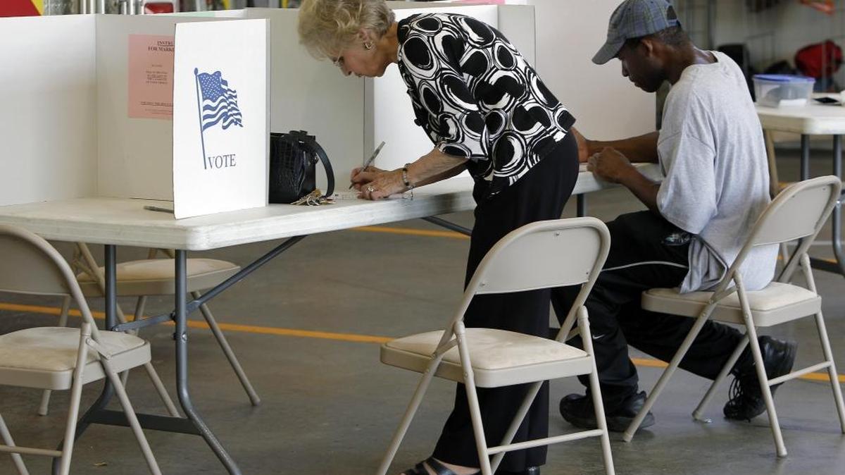 FILE – During 2014 midterm elections, North Carolina voters cast their ballots at the Clayton Fire Station in Johnston County. This November, federal cybersecurity officials will test North Carolina’s electronic voting-related equipment for possible vulnerabilities that hackers could exploit. The partnership is part of a nationwide effort to beef up cybersecurity.