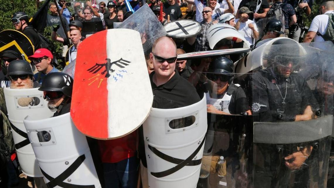 White nationalist demonstrators use shields as they guard the entrance to Lee Park in Charlottesville, Va., Saturday, Aug. 12, 2017.