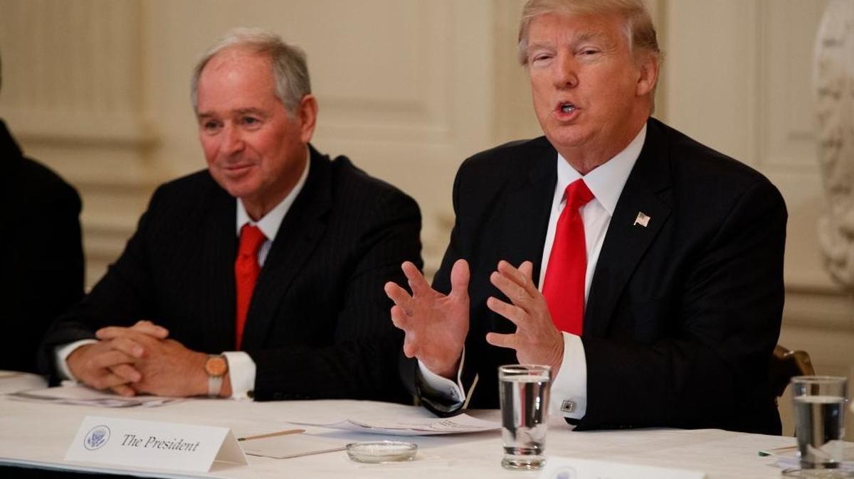 Blackstone CEO Stephen Schwarzma listens at left as President Donald Trump speaks during a meeting with business leaders in the State Dining Room of the White House in Washington, Friday, Feb. 3, 2017.