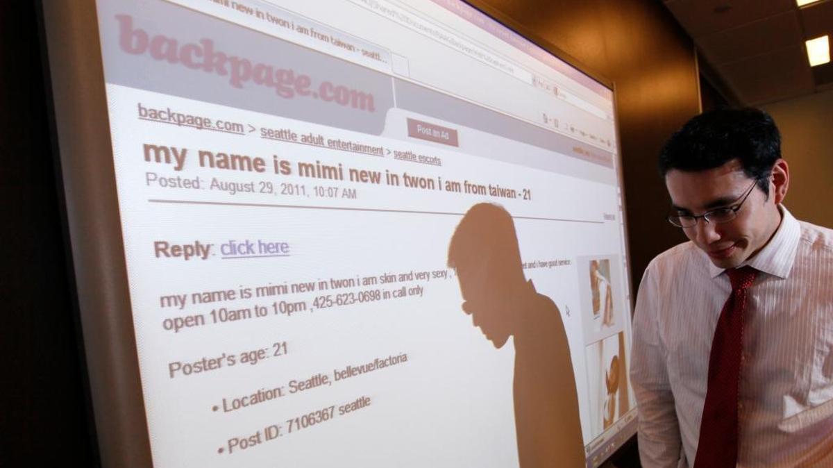 Washington state assistant attorney general Jonathan Mark walks past a display of a Backpage.com ad following a news conference about action being taken against the adult services site Wednesday, Aug. 31, 2011, in Seattle. Attorneys general in all 50 states sent a letter to Congress on Aug. 16, 2017 asking lawmakers to make clear state and local law enforcement agencies have the authority to investigate and prosecute companies that profit from sex trafficking and crimes against children.