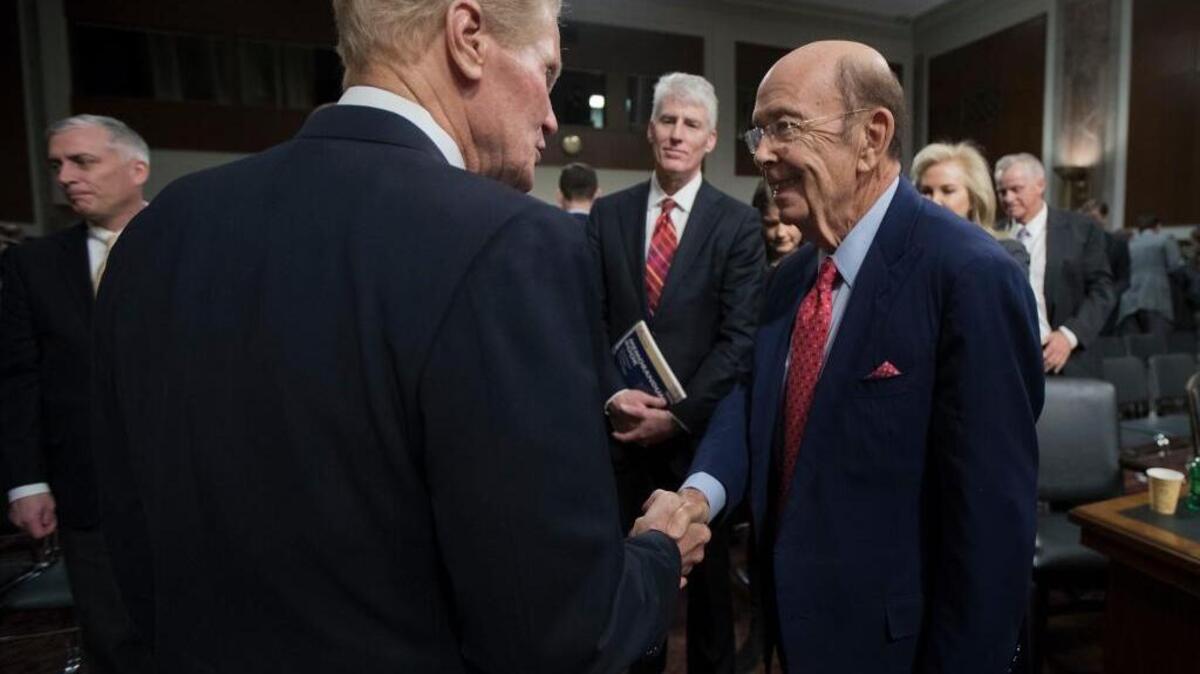 The Senate Commerce Committee's ranking member, Sen. Bill Nelson, D-Fla., left, with Commerce Secretary-designate Wilbur Ross. If confirmed by the Senate, Ross would oversee the National Oceanic and Atmospheric Administration, whose climate scientists fear what a Trump administration could mean for them.