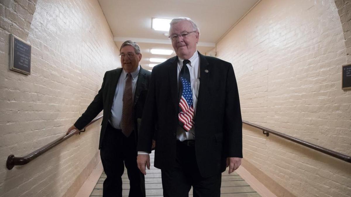 Rep. Michael C. Burgess, R-Texas, left, and Rep. Joe Barton, R-Texas, right, walk to a meeting with fellow House Republicans as work in Congress resumes following the August recess, at the Capitol in