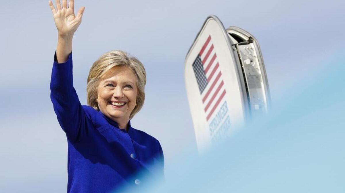 Democratic presidential candidate Hillary Clinton waves as she boards her campaign plane at Westchester County Airport, in White Plains, N.Y., on Wednesday, Sept. 21, 2016.