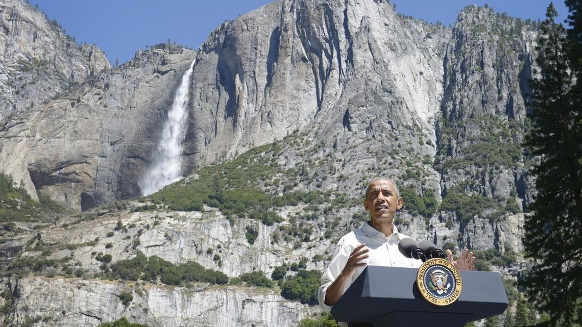 President Barack Obama is seen in front of a backdrop of Yosemite Falls as he gives talks about the importance of the National Park Service during an event near Cook’s Meadow in Yosemite National Park on Saturday, June 18, 2016.