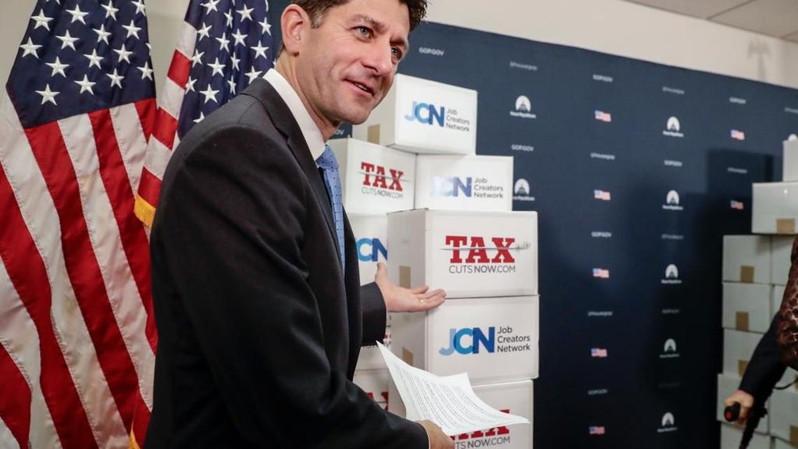 Speaker of the House Paul Ryan, R-Wis., points to boxes of petitions supporting the Republican tax reform bill.