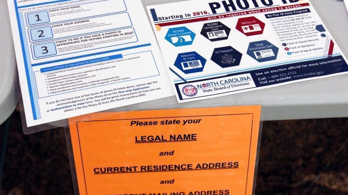 Information placards on the welcoming voters' table in the lobby of the Paul Green Theatre on the UNC-CH campus Tuesday morning, May 6, 2014 explain North Carolina’s new voter ID requirements.