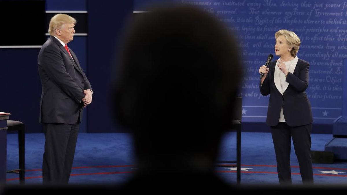 Hillary Clinton and Donald Trump debate at Washington University, Sunday, Oct. 9, 2016, in St. Louis. A new analysis published by Pew Research Center suggests that at least a third of Americans are "worn out" by the political content they find on social media, and more than 80 percent of users try to ignore political posts with which they disagree.