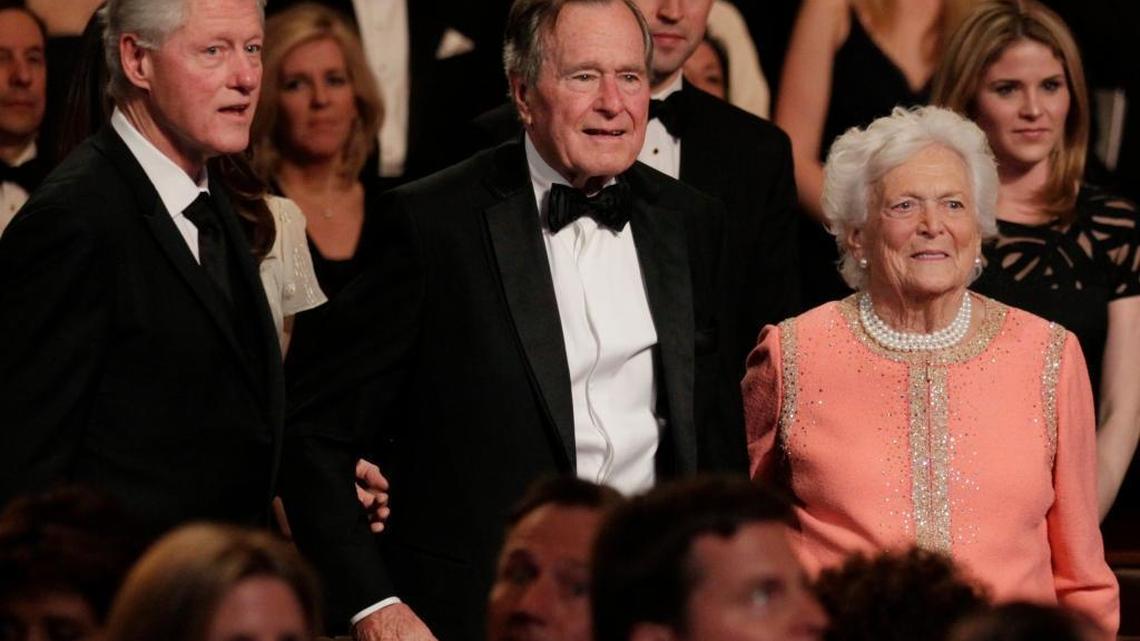 From left, former President Bill Clinton, former President George H. W. Bush and his wife Barbara Bush stand for the National Anthem at the Kennedy Center, Monday, March 21, 2011, in Washington.
