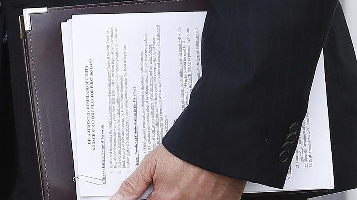 Kansas Secretary of State Kris Kobach carried a document out of a meeting with Donald Trump Sunday that suggested he may be in line for a position at the Department of Homeland Security.