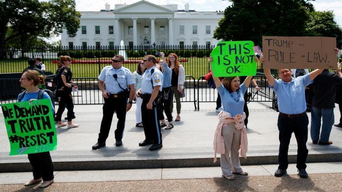 Demonstrators gather outside the White House a day after President Donald Trump fired FBI Director James Comey, Wednesday, May 10, 2017, in Washington.