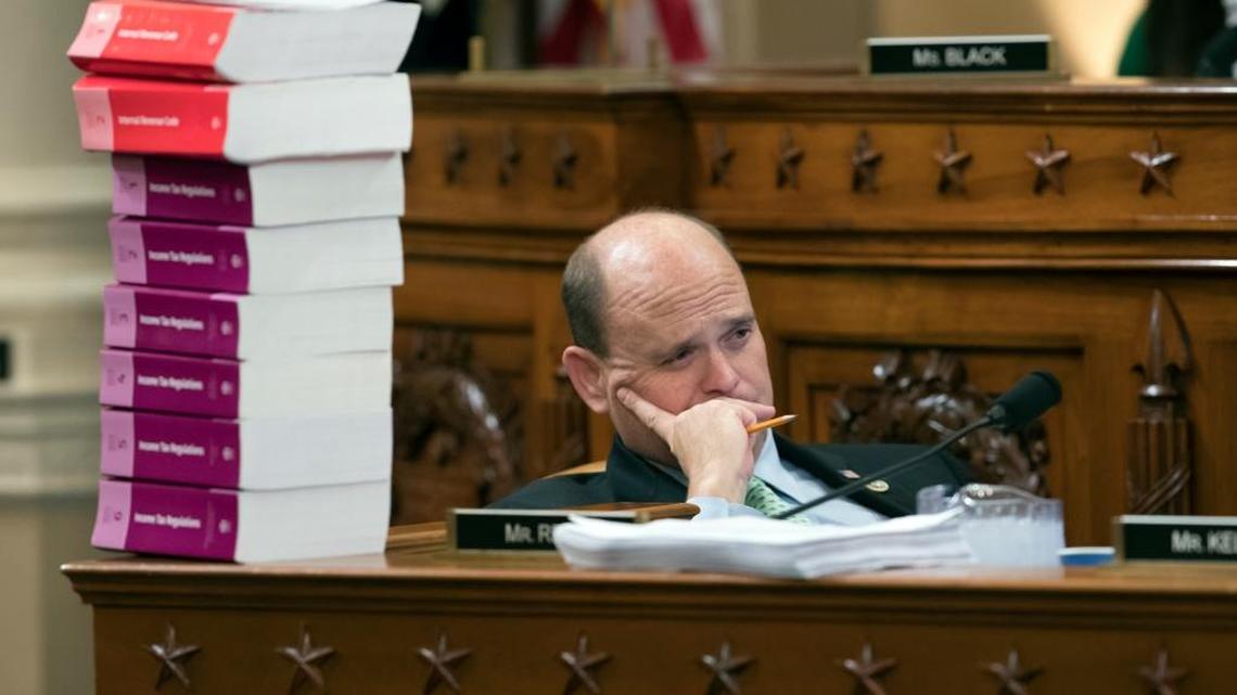 Rep. Tom Reed, R-N.Y., listens as he sits next to a stack of IRS Code volumes as the House Ways and Means Committee begins writing the GOP's far-reaching tax overhaul.