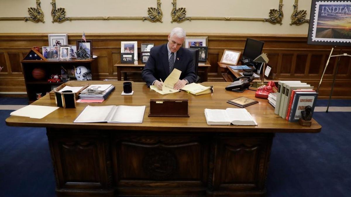 Vice President-elect Mike Pence signs off on paperwork sending Indiana's electors to the electoral college at the Statehouse Friday, Dec. 2, 2016, in Indianapolis.