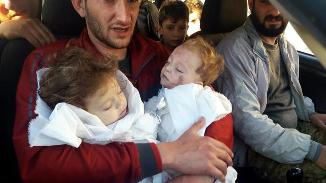In this Tuesday April 4, 2017 file photo, Abdel Hameed Alyousef, 29, holds his twin babies who were killed during a suspected chemical weapons attack, in Khan Sheikhoun in the northern province of Idlib, Syria. Turkey's health minister, Recep Akdag said Tuesday, April 11, 2017, that test results conducted on victims of the chemical attack in Khan Sheikhoun confirm that sarin gas was used. Officials from the World Health Organization and the Organization for the Prohibition of Chemical Weapons participated in the autopsies.