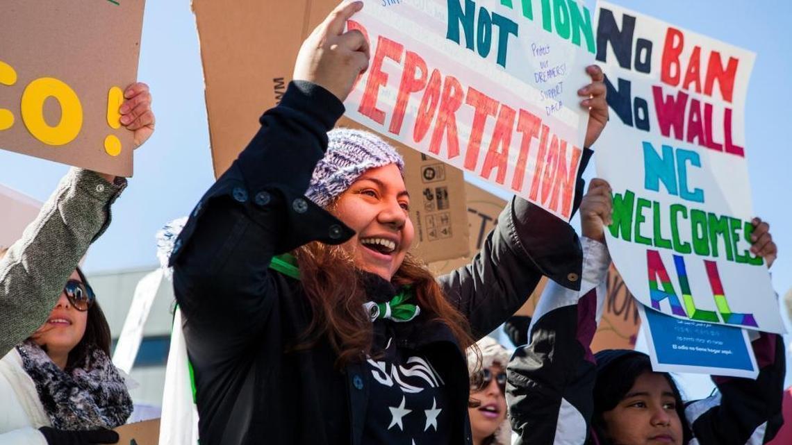 A DACA recipient and student, Linda David, center and her sister Natalie David, right, voice their opposition to the immigration and refugee policies of President Donald Trump during a rally on Halifax Mall on Saturday Feb. 4, 2017, in Raleigh, NC.