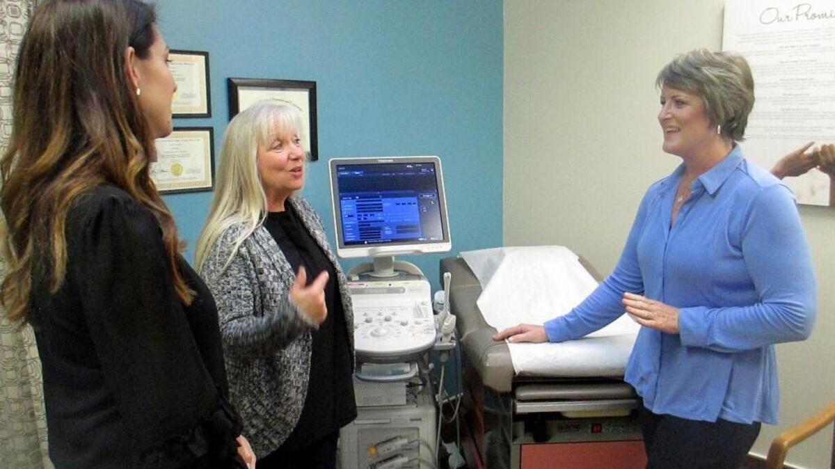 Blayne Wittig, executive director of Options for Women of California, left, a center in Concord, Calif., Debbie Whittaker, nurse manager, center, and Christine Vatuone, president and CEO of Informed Choices, talk at Informed Choices, a crisis pregnancy center in Grilroy, Calif.