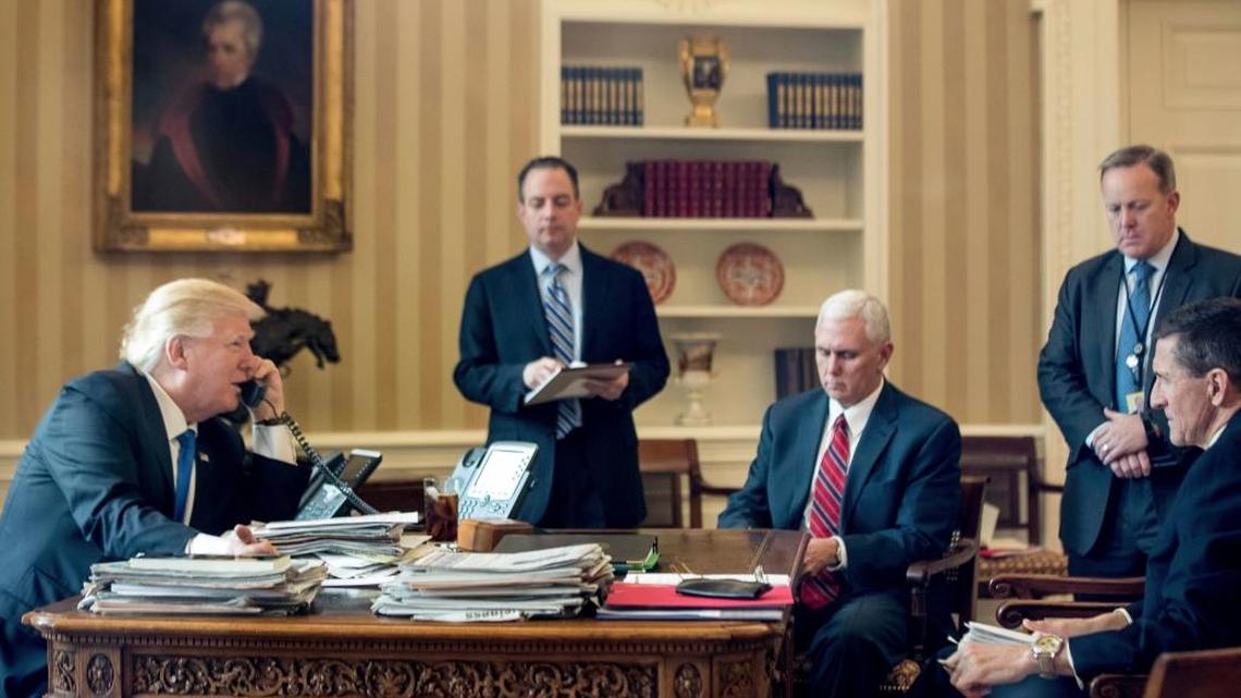 President Donald Trump, accompanied by, from second from left, Chief of Staff Reince Priebus, Vice President Mike Pence, White House press secretary Sean Spicer and National Security Adviser Michael Flynn, speaks on the phone with with Russian President Vladimir Putin on Jan. 28 in the Oval Office at the White House in Washington.