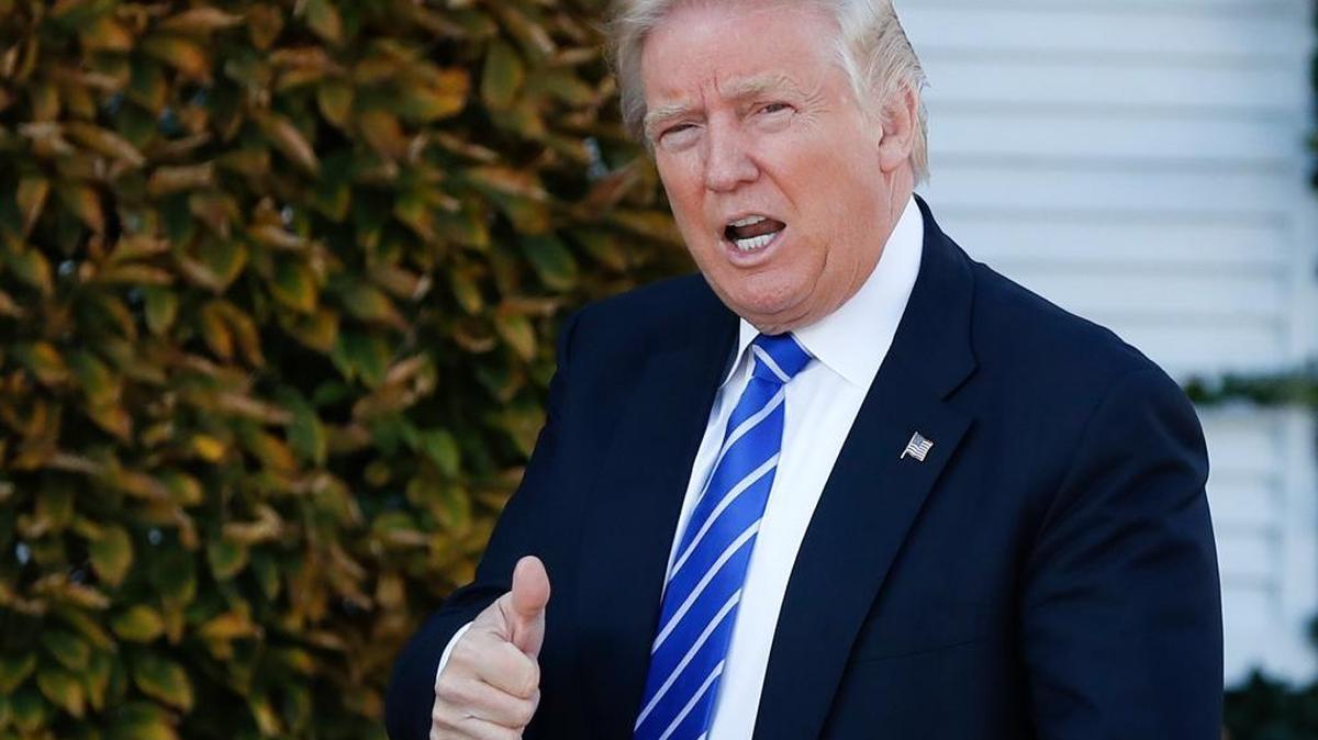 FILE - In this Nov. 19, 2016, file photo, President-elect Donald Trump gives the thumbs-up as he arrive at the Trump National Golf Club Bedminster clubhouse in Bedminster, N.J. Trump, ethics attorneys and good-government groups are all grappling with how to navigate being a president with extraordinary international and domestic business ties. While others in government are bound by rules and regulations about their business ties, the president has fewer such restrictions.