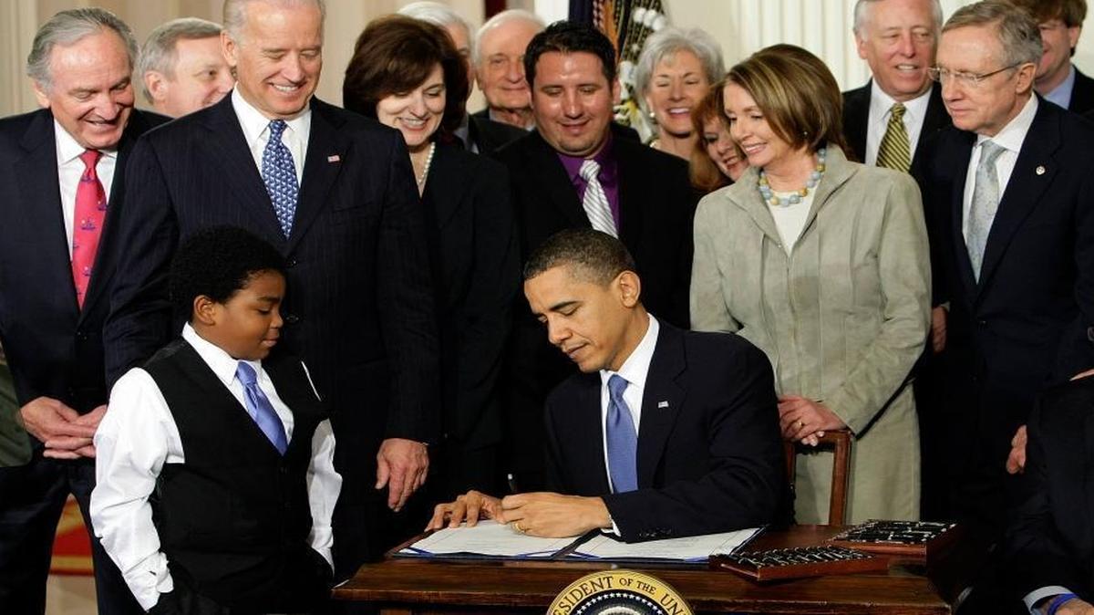 FILE - In this Tuesday, March 23, 2010 file photo, President Barack Obama signs the Patient Protection and Affordable Care Act in the East Room of the White House in Washington. "Obamacare" led to health care coverage for some 20 million Americans, including about 4 million Hispanics and 3 million blacks, according to federal statistics. However, its fate is uncertain because of Trumpâ€™s vow to repeal and replace it.