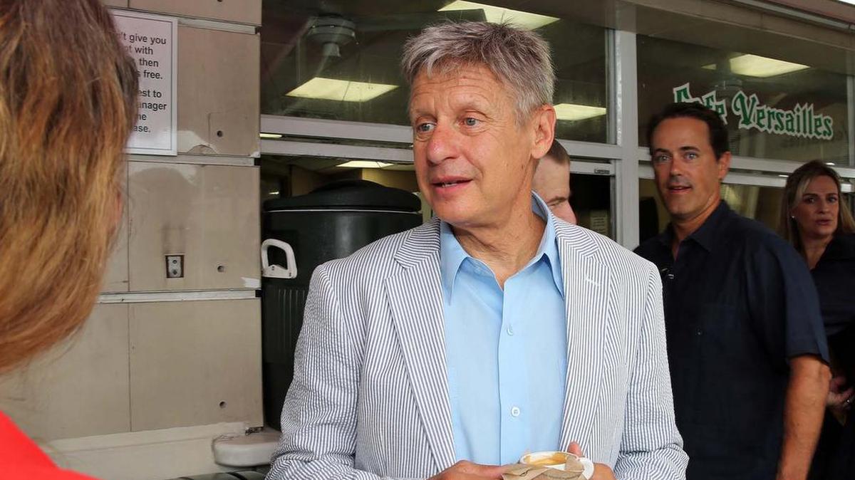 Libertarian Presidential Candidate Gary Johnson has a shot of Cuban coffee as he speaks with supporters outside Versailles Cuban Restaurant in Little Havana on Thursday.
