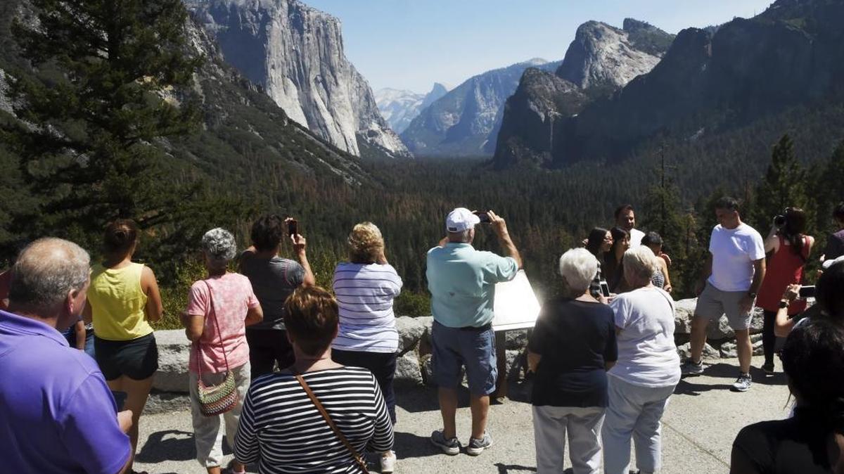 Visitors take photos of Yosemite Valley from the Tunnel View point on the day staff and visitors celebrated the National Park Service's 100-year anniversary, Aug. 25, 2016.