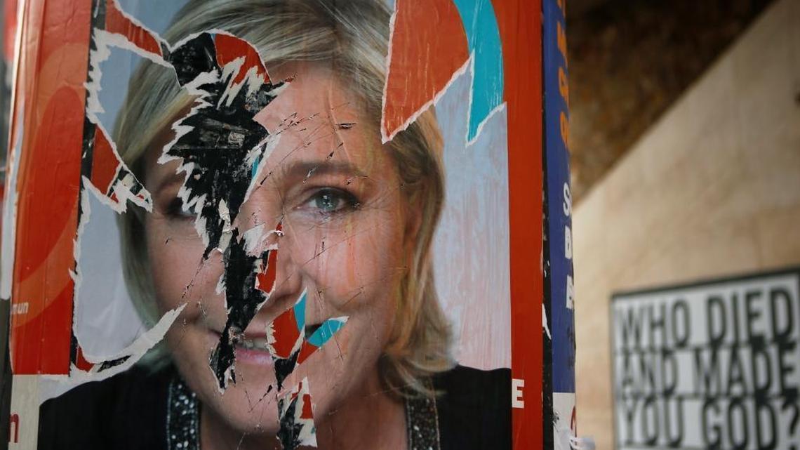 A torn campaign poster for French far-right presidential candidate Marine Le Pen in Paris. Le Pen’s rival, centrist Emmanuel Macron, was allegedly the target of Russian state hackers.