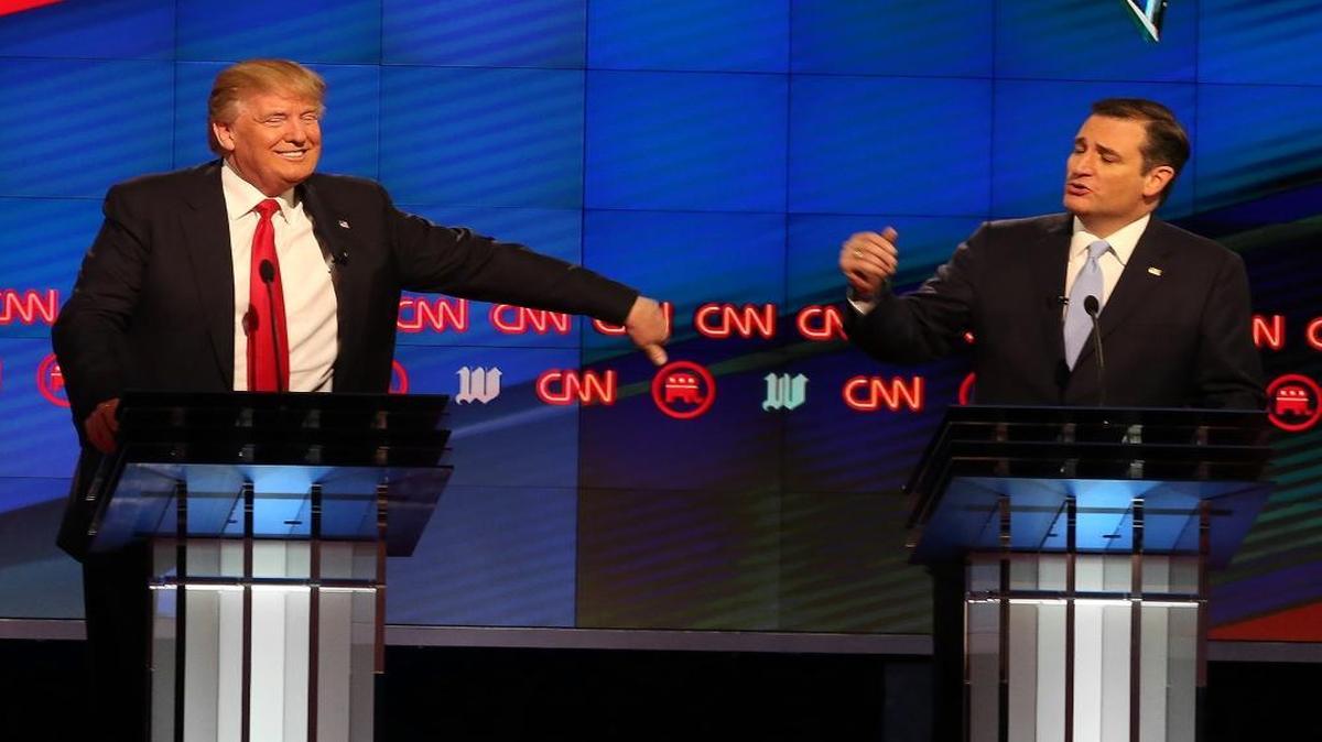 Donald Trump reacts as Sen. Ted Cruz, R-Texas, rebukes him for a comment he made during the Republican presidential debate at the University of Miami on Thursday, March 10, 2016.