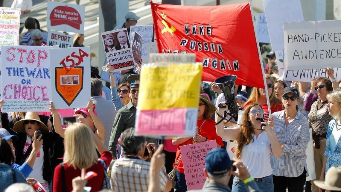 People protest outside the Junior Seau Beach Community Center as U.S. Rep. Darrell Issa, R-Calif., holds a town hall meeting inside on March 11, 2017, in Oceanside, Calif.