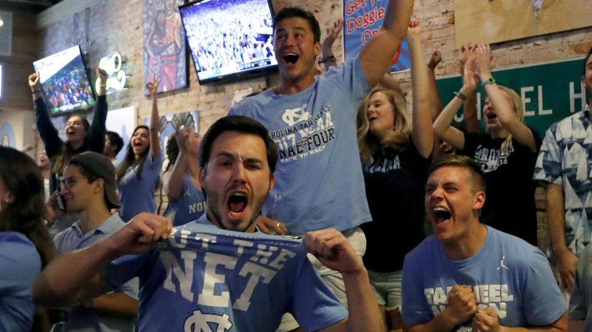 UNC fans go wild after a big play for the Tar Heels as they watch the NCAA game against Oregon at Sup Dogs restaurant on Franklin Street in Chapel Hill on April 1, 2017.