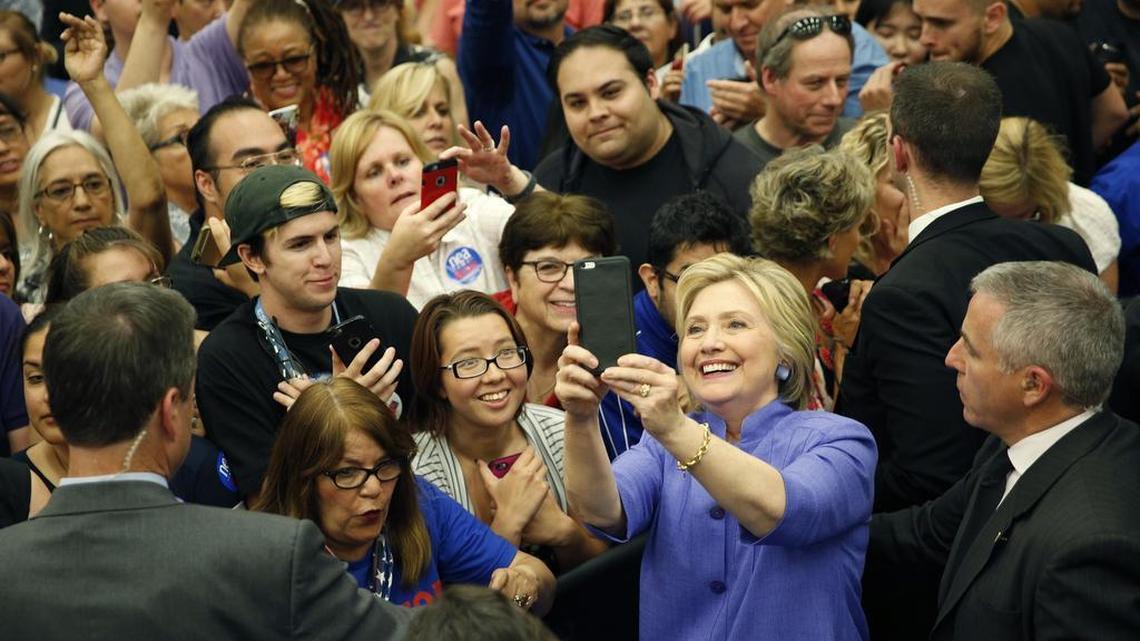 Democratic presidential candidate Hillary Clinton takes a selfie with supporters at a rally Friday in San Bernardino, Calif.