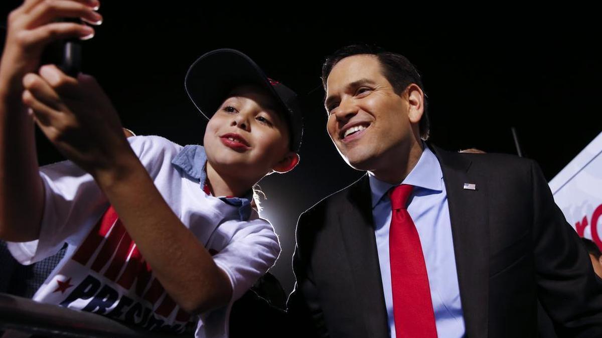 Republican presidential candidate, Sen. Marco Rubio, R-Fla., poses for photographs during a campaign rally in Hialeah, Fla., on Wednesday.
