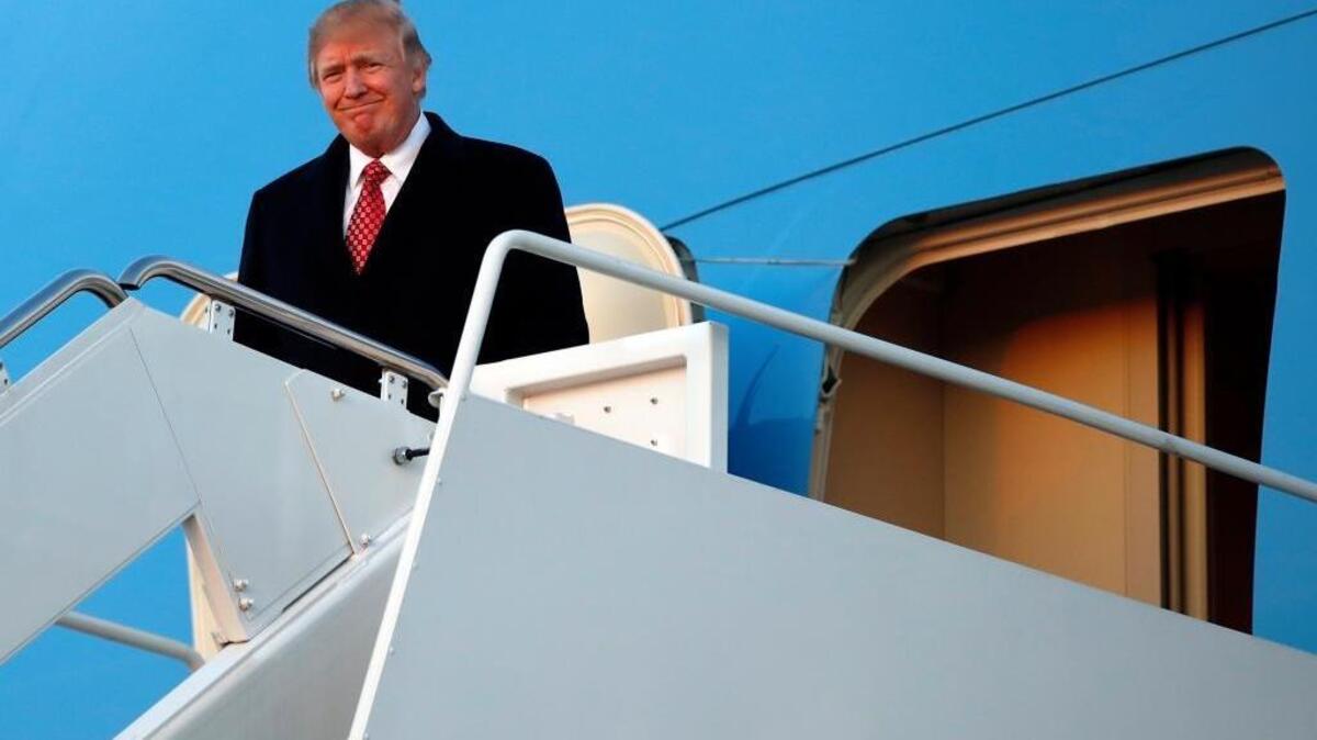 President Donald Trump disembarks from Air Force One as he arrives Sunday, March 5, 2017, at Andrews Air Force Base, Md.