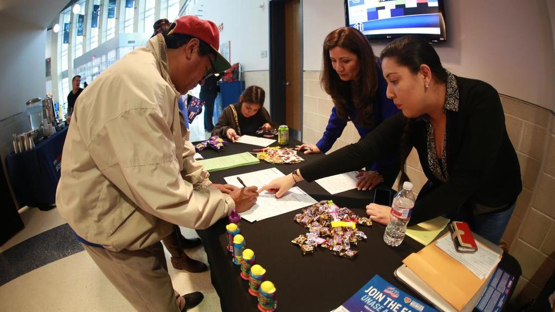 Sandra Tovar, DFW Coordinator of Mi Familia Vota pictured on the right, helps newly naturalized citizens register to vote. Tovar, a resident of Fort Worth, said many legal immigrants tell her they want to become U.S. citizens in time for the November presidential election.