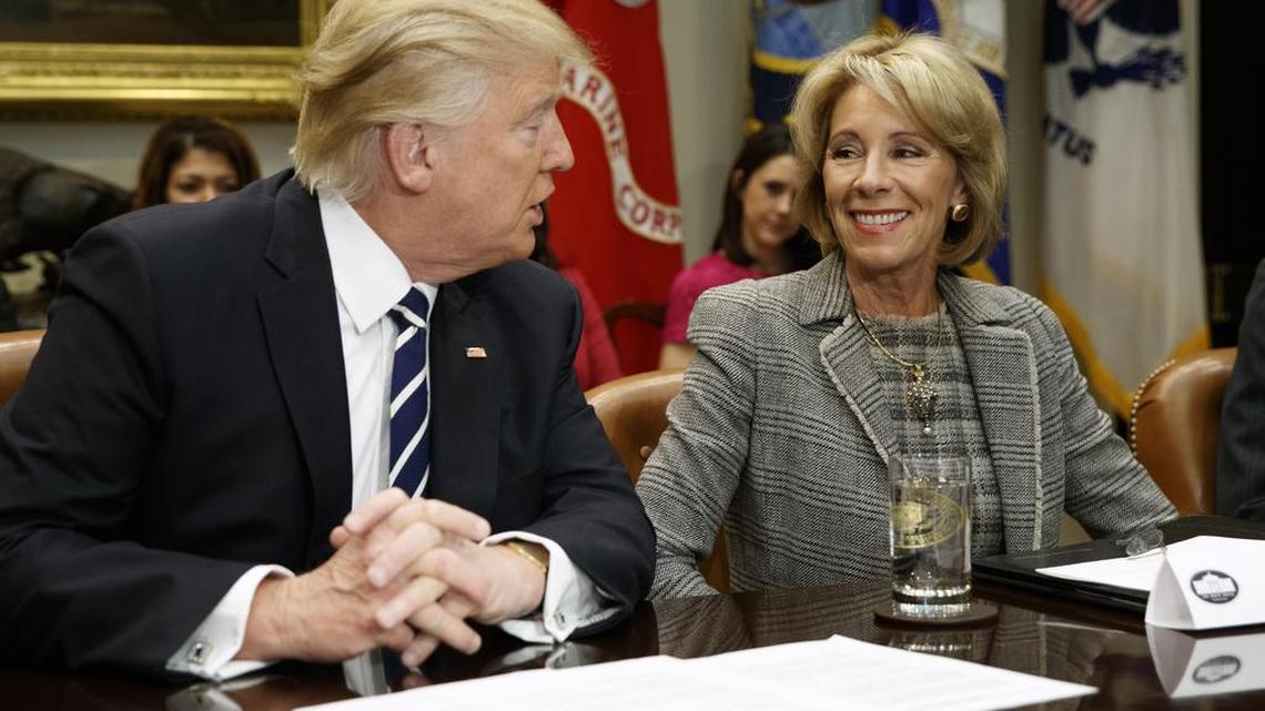 President Donald Trump looks at Education Secretary Betsy DeVos as he speaks during a meeting with parents and teachers, Tuesday, Feb. 14, 2017, in the Roosevelt Room of the White House in Washington.