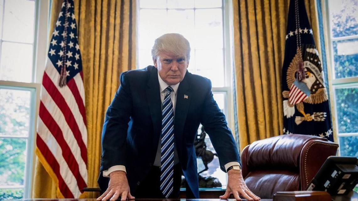 In this April 21, 2017, file photo, President Donald Trump poses for a portrait in the Oval Office in Washington.