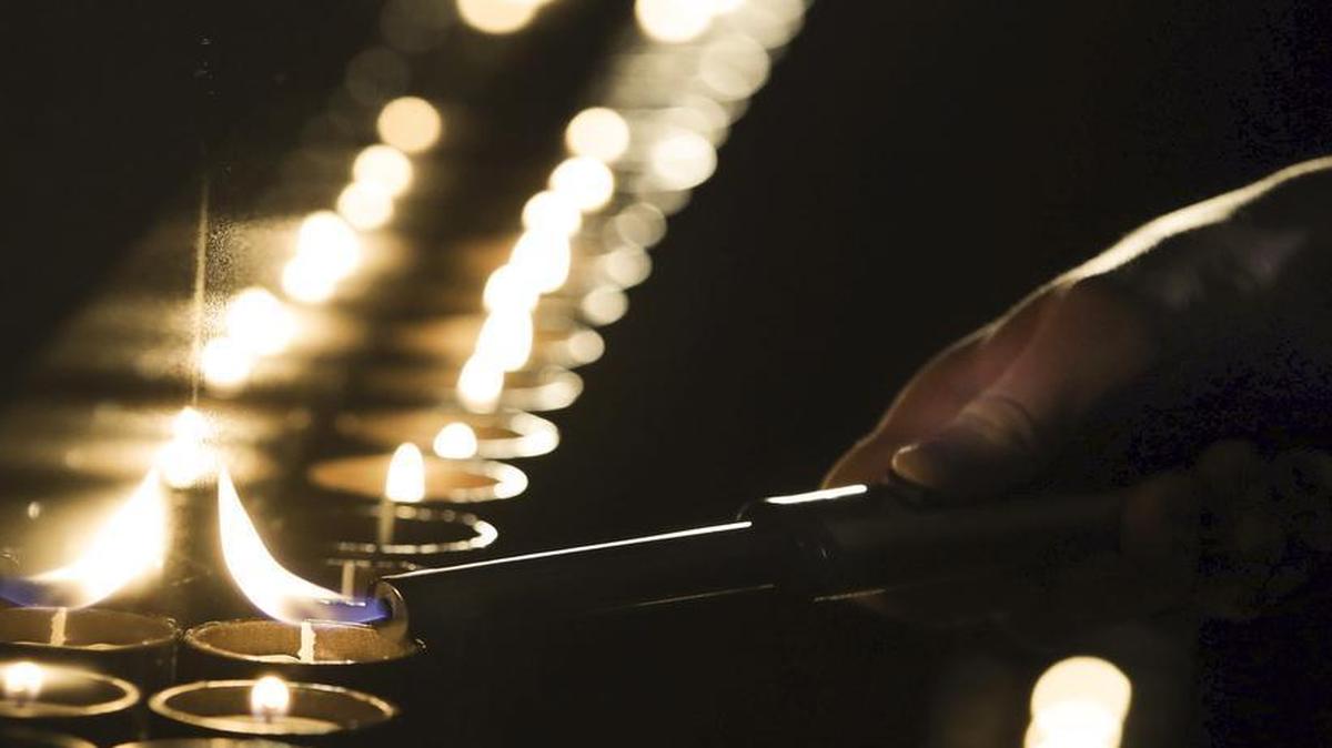 A candle is lit at a ceremony marking the International Holocaust Remembrance Day in the Jewish Museum and Tolerance Center in Moscow, Russia, Jan. 27, 2017.