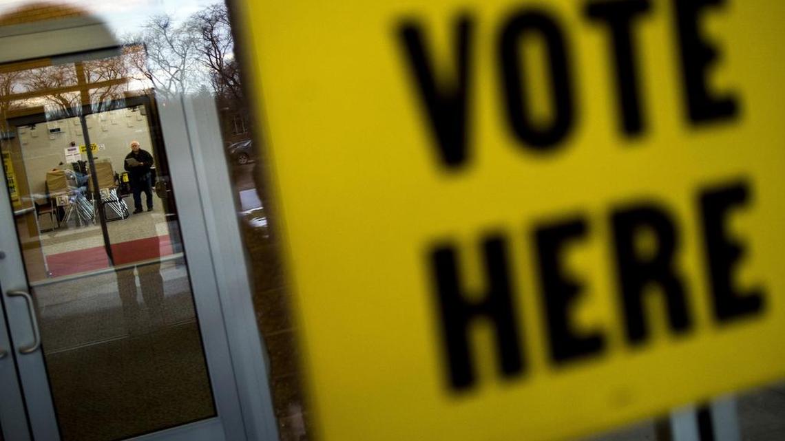 Voters leave the polls during the primary election at Mott Community College in Flint, Mich., on March 8, 2016. Presidential candidates in both parties were looking to Michigan for one of the largest delegate hauls in the bruising nominating contests.