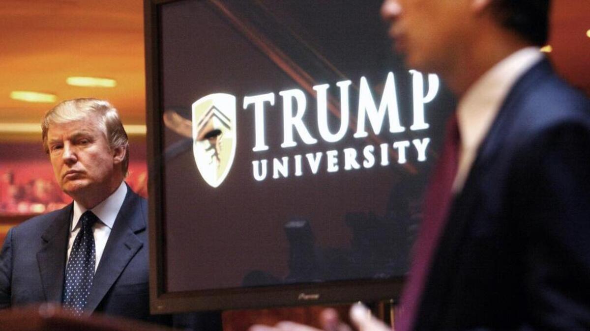 Donald Trump, left, listens as Michael Sexton introduces him at a news conference in New York where he announced the establishment of Trump University on May 23, 2005.